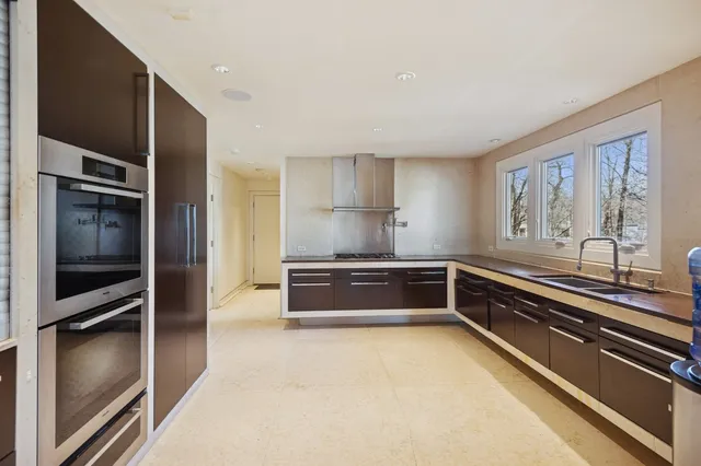 a kitchen with stainless steel appliances granite countertop a stove and a refrigerator