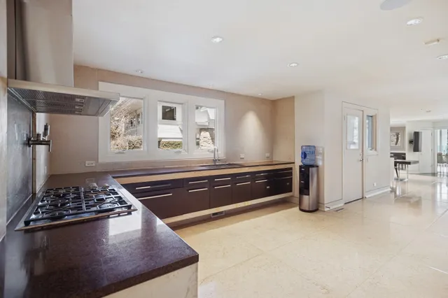 a spacious bedroom with a bed and a dresser