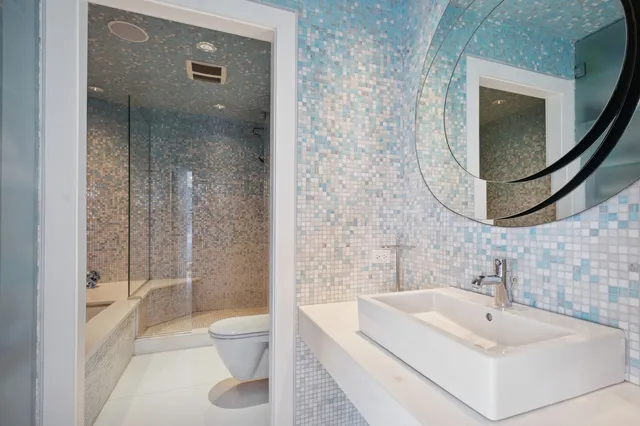 a room with gym equipment and wooden floor