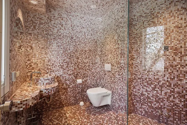a view of a backyard with table and chairs under an umbrella with a large tree