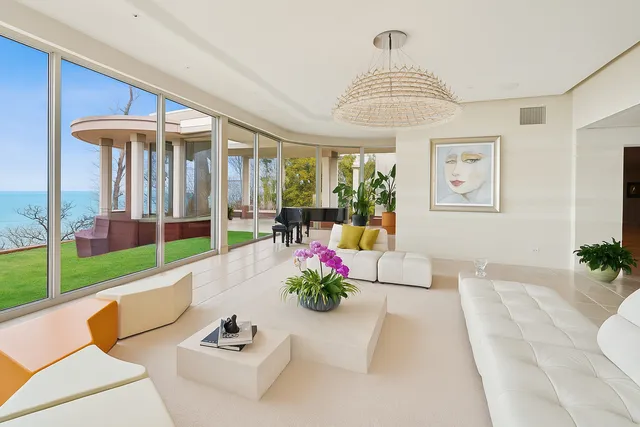 a living room with furniture and large windows