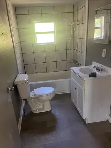 a bathroom with a sink a toilet and bathtub
