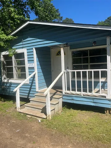 a view of a house with wooden fence and a window
