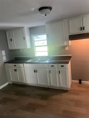a kitchen with granite countertop a sink and a stove