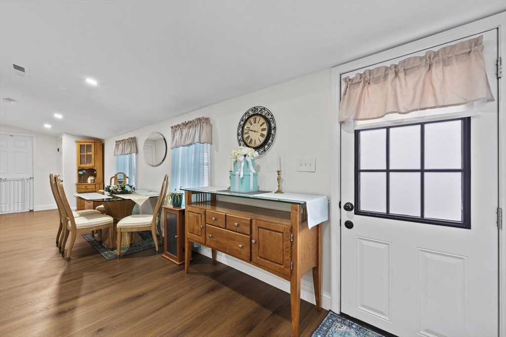 23 Bennett Lane Lancaster, MA 01523 - Photo 11 of 29 a living room with furniture a fireplace and a large window
