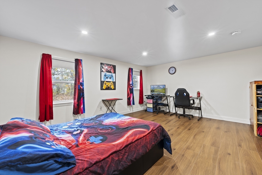 23 Bennett Lane Lancaster, MA 01523 - Photo 16 of 29 a bed room with a bed and a chair