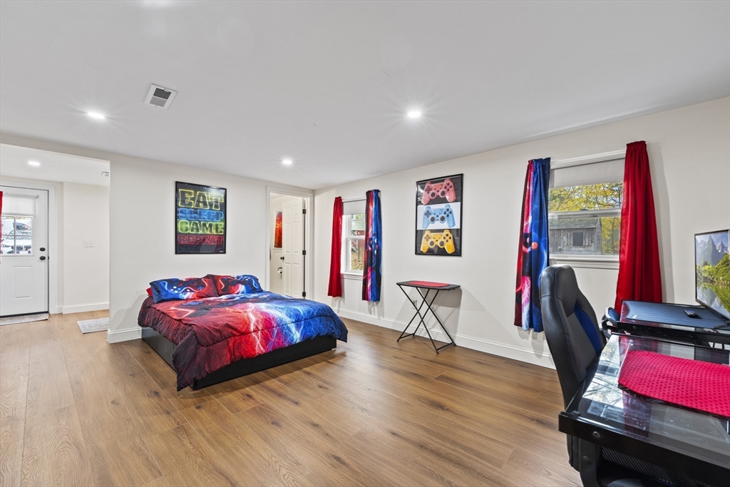 23 Bennett Lane Lancaster, MA 01523 - Photo 17 of 29 a living room with furniture and a wooden floor