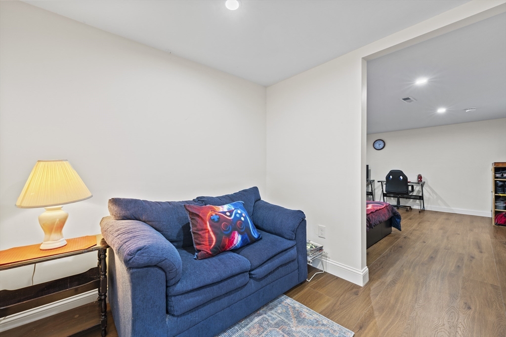 23 Bennett Lane Lancaster, MA 01523 - Photo 18 of 29 a living room with furniture and a wooden floor