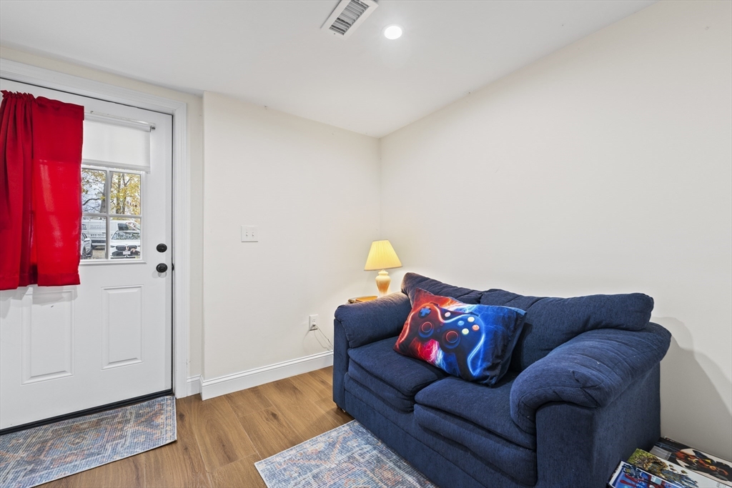 23 Bennett Lane Lancaster, MA 01523 - Photo 19 of 29 a living room with furniture and wooden floor