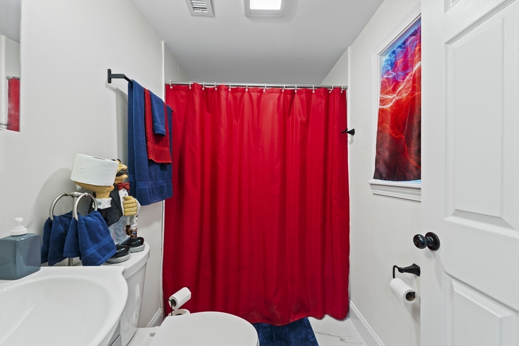 23 Bennett Lane Lancaster, MA 01523 - Photo 20 of 29 a bathroom with a sink vanity mirror and tub