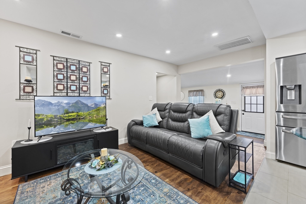 23 Bennett Lane Lancaster, MA 01523 - Photo 2 of 29 a living room with furniture and painting on the wall