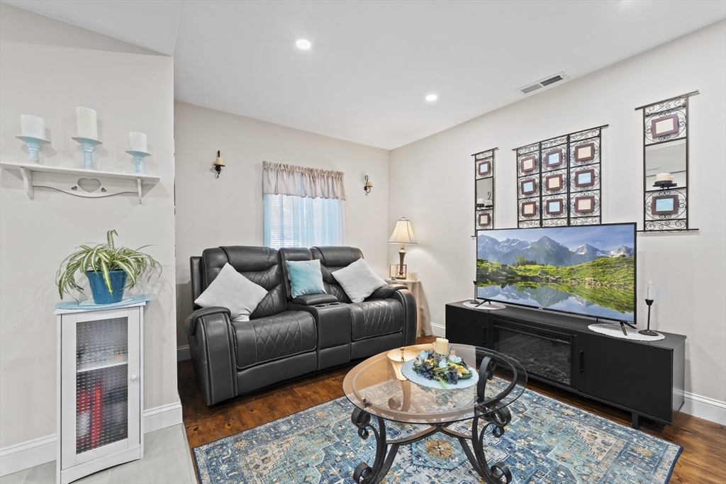 23 Bennett Lane Lancaster, MA 01523 - Photo 3 of 29 a living room with furniture and a large window