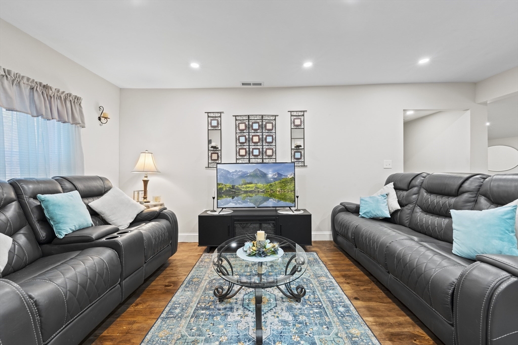 23 Bennett Lane Lancaster, MA 01523 - Photo 4 of 29 a living room with furniture and a rug