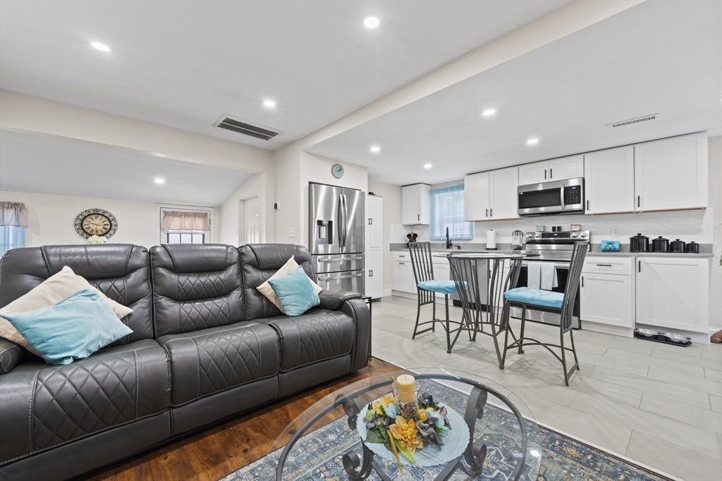 23 Bennett Lane Lancaster, MA 01523 - Photo 5 of 29 a living room kitchen with furniture and a kitchen view