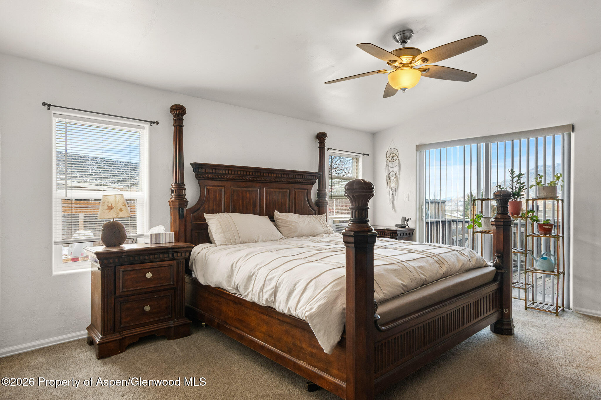 106 Cedar Circle Parachute, CO 81635 - Photo 19 of 35 a bedroom with a bed and a chandelier
