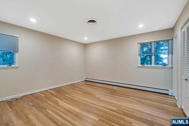 32 Rock Road Englewood Cliffs, NJ 07632 - Photo 15 of 30 an empty room with wooden floor and windows