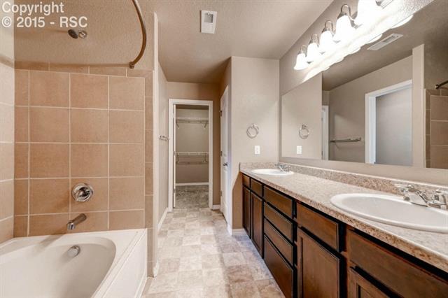944 Diamond Rim Drive Colorado Springs, CO 80921 - Photo 20 of 28 Bright, double vanity master bath with view of walk in closet and linen closet.