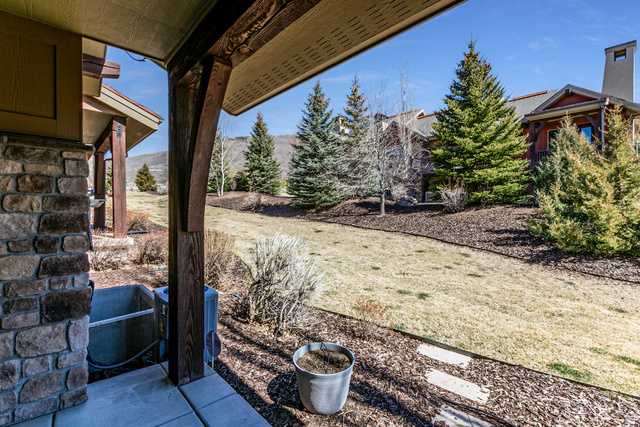 5326 North Oldgate Road Heber City, UT 84032 - Photo 26 of 32 Covered patio with stone pillar and exposed wood beam