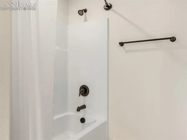 a bathroom with a shower and a sink