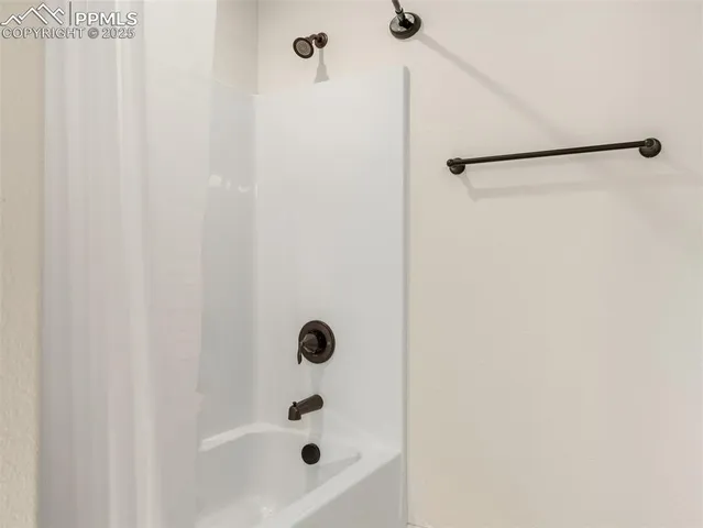 a bathroom with a shower and a sink