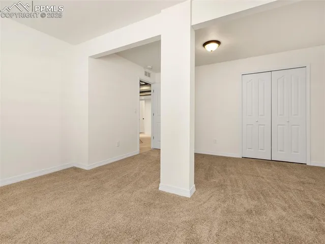 an empty room with closet area