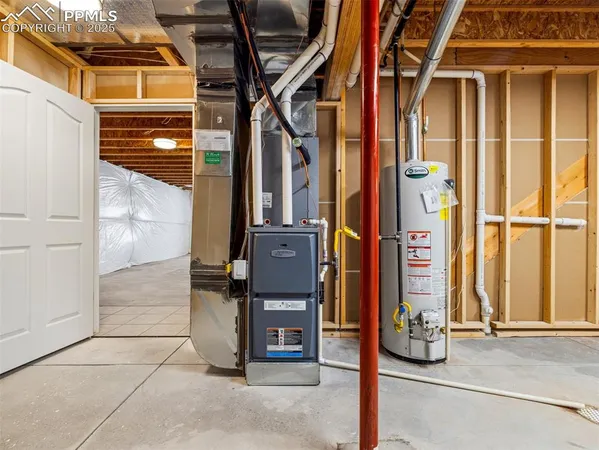 a view of a kitchen with kitchen island a sink stainless steel appliances and cabinets