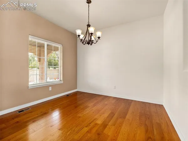 a view of wooden floor and windows in a room