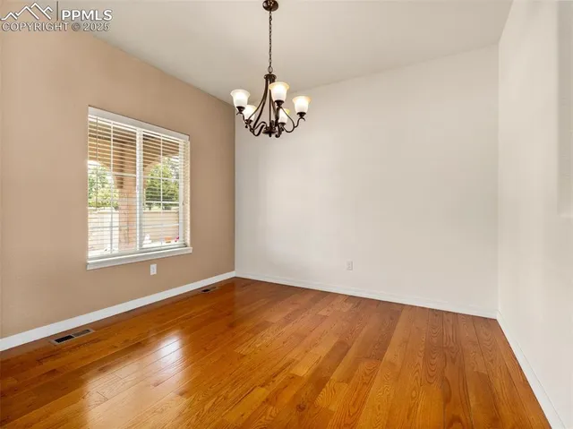 a view of wooden floor and windows in a room