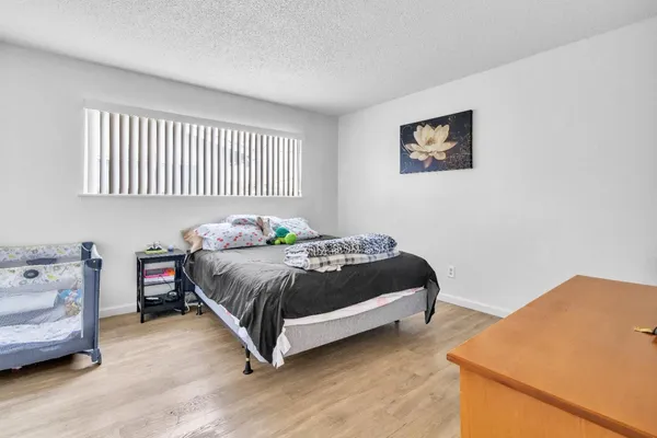 a bedroom with a bed and flat screen tv