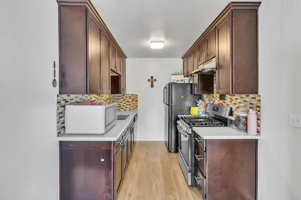 a view of room with window and wooden floor