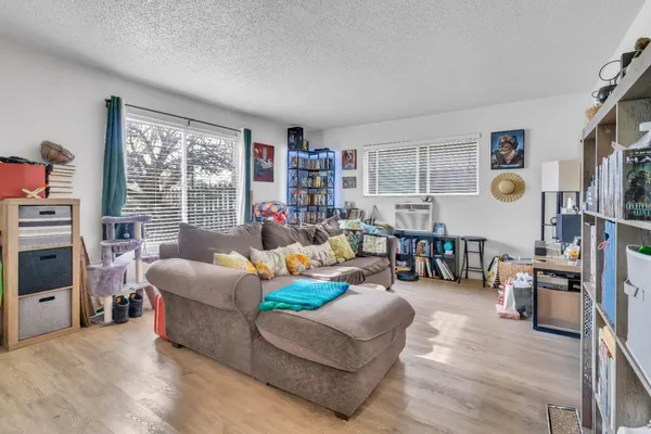 a living room with furniture and a wooden floor