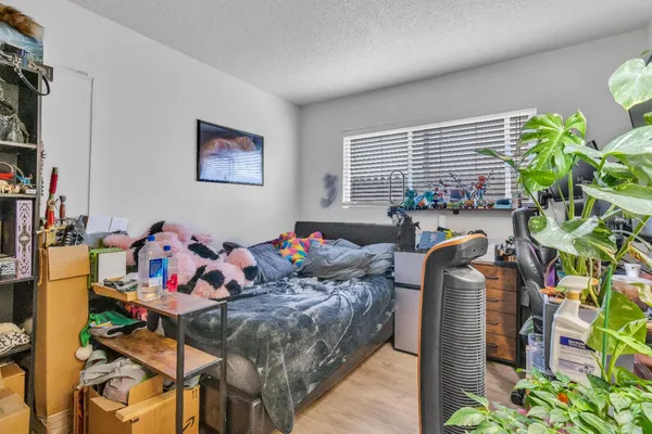 a kitchen with a sink and a stove with wooden floor