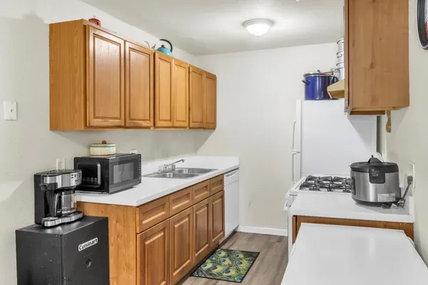 a kitchen with stainless steel appliances granite countertop a sink and a stove