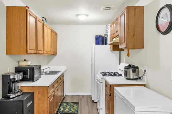 a bedroom with a bed a dresser next to a window