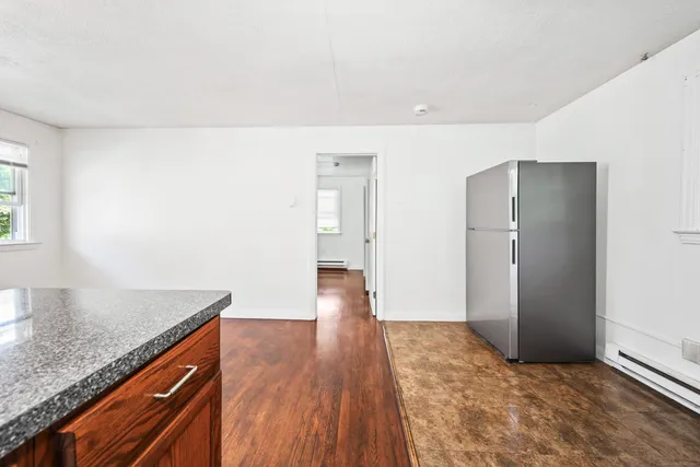 a view of hallway with wooden floor