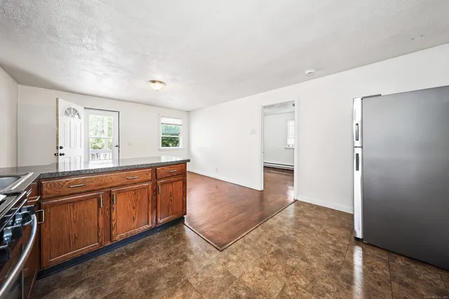 a spacious bathroom with a granite countertop sink and a mirror