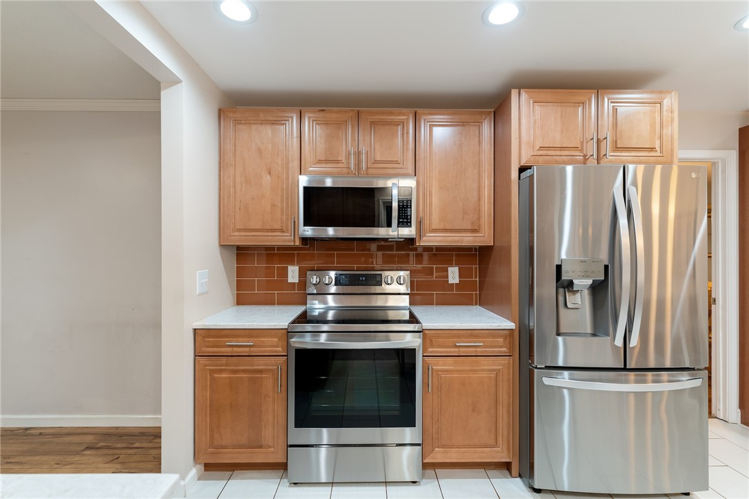 1014 East Queen Street Pendleton, SC 29670 - Photo 14 of 43 Gleaming stainless steel appliances and warm wood cabinetry define this inviting kitchen space.