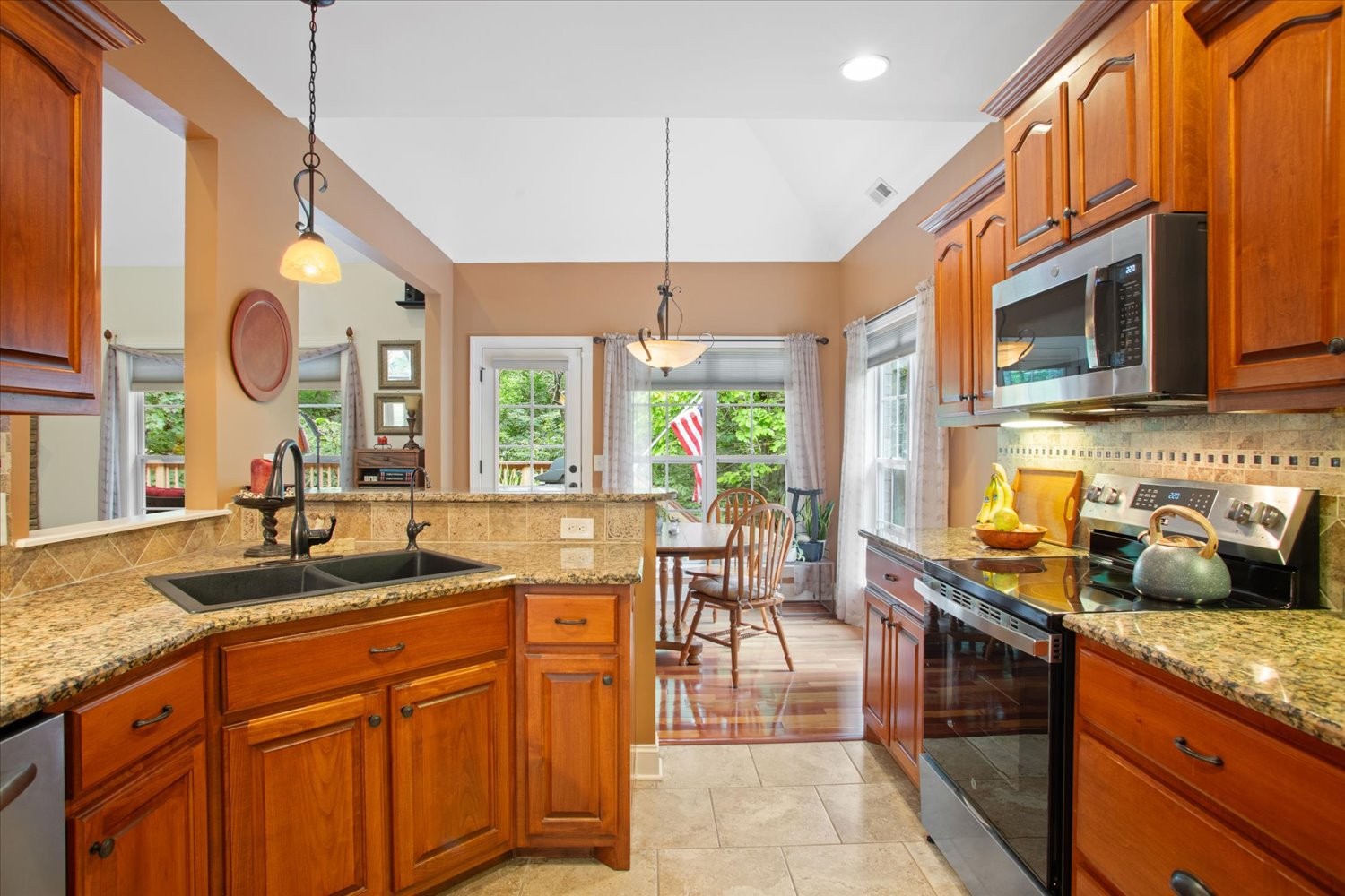 1765 Sugar Ridge Road Spring Hill, TN 37174 - Photo 16 of 44 a kitchen with stainless steel appliances granite countertop a sink a stove and a wooden cabinets