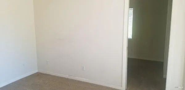 a picture of a room with a ceiling fan