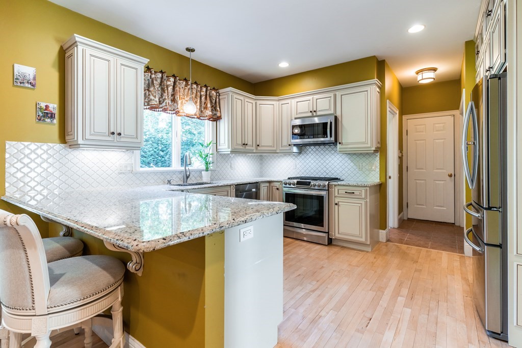 139 Shade Street Lexington, MA 02421 - Photo 12 of 42 a kitchen with stainless steel appliances granite countertop a sink and a refrigerator