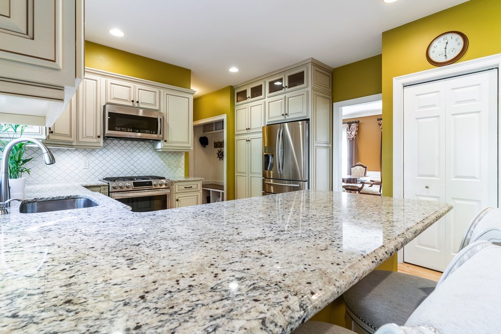 139 Shade Street Lexington, MA 02421 - Photo 13 of 42 a kitchen with stainless steel appliances granite countertop a stove a sink and a refrigerator