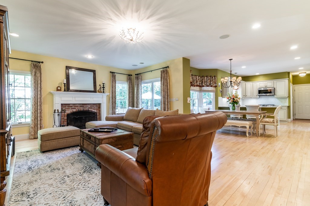 139 Shade Street Lexington, MA 02421 - Photo 15 of 42 a living room with furniture a fireplace and a table