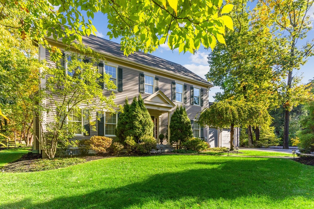139 Shade Street Lexington, MA 02421 - Photo 2 of 42 a front view of a house with a garden