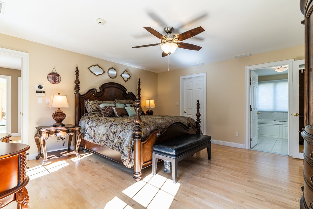 139 Shade Street Lexington, MA 02421 - Photo 30 of 42 a bedroom with a bed and wooden floor