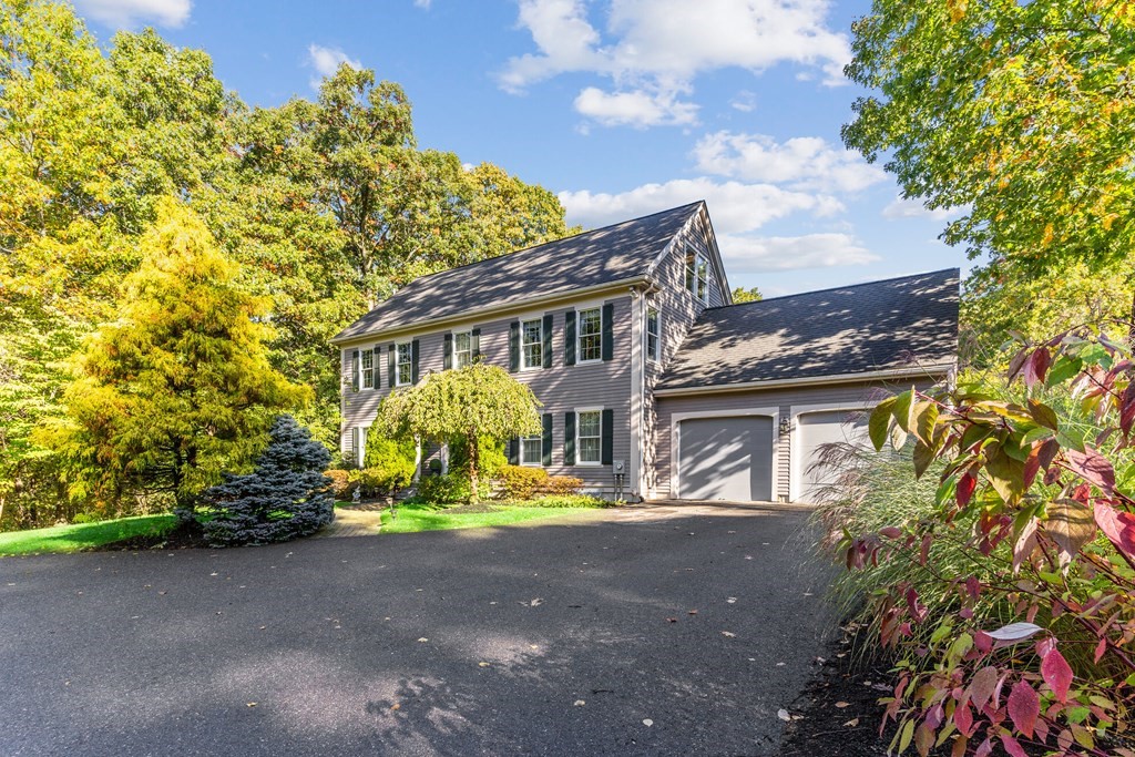 139 Shade Street Lexington, MA 02421 - Photo 3 of 42 a view of a house with large trees and plants