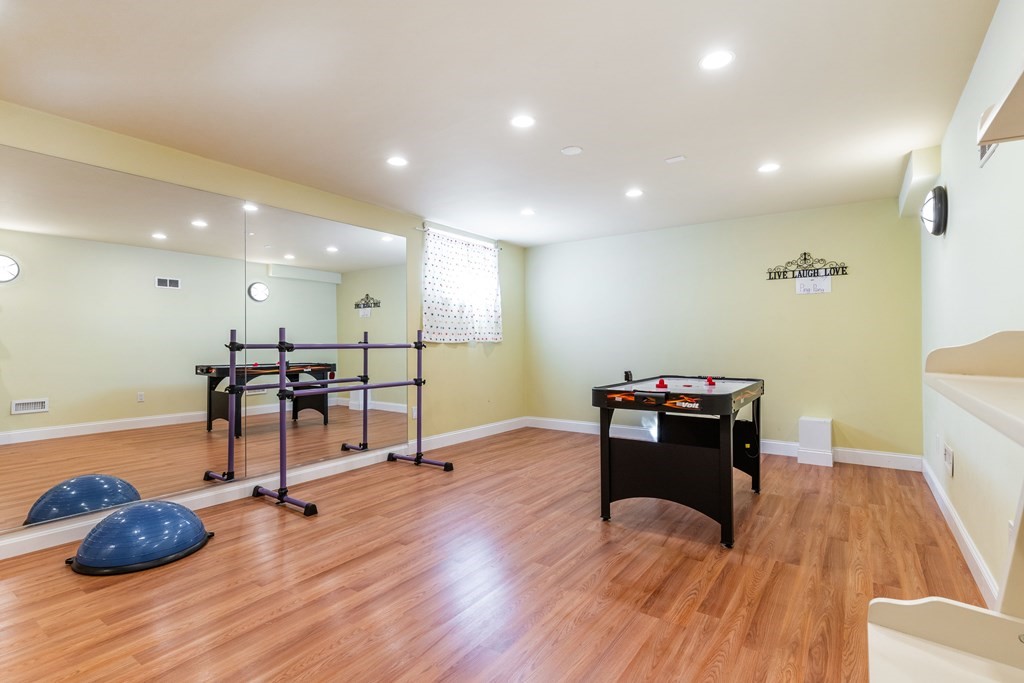 139 Shade Street Lexington, MA 02421 - Photo 39 of 42 a view of a room with gym equipment and wooden floor