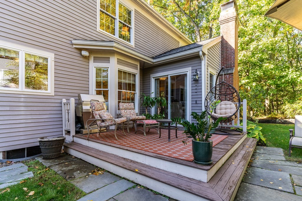 139 Shade Street Lexington, MA 02421 - Photo 41 of 42 a view of a house with a chairs in patio