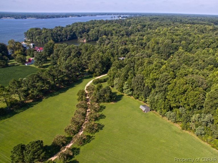 1178 Providence Road Deltaville, VA 23043 - Photo 12 of 50 Aerial of 8.2 acres with over 740' of waterfront, including front fields with tractor shed and woodlands. You can just see the roof of the house peeking out of the trees.