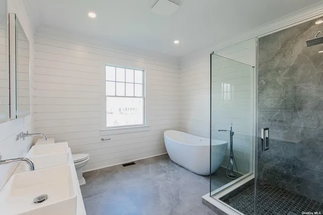 a bathroom with a sink toilet and mirror