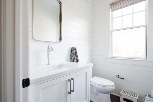 a bathroom with a sink toilet and mirror